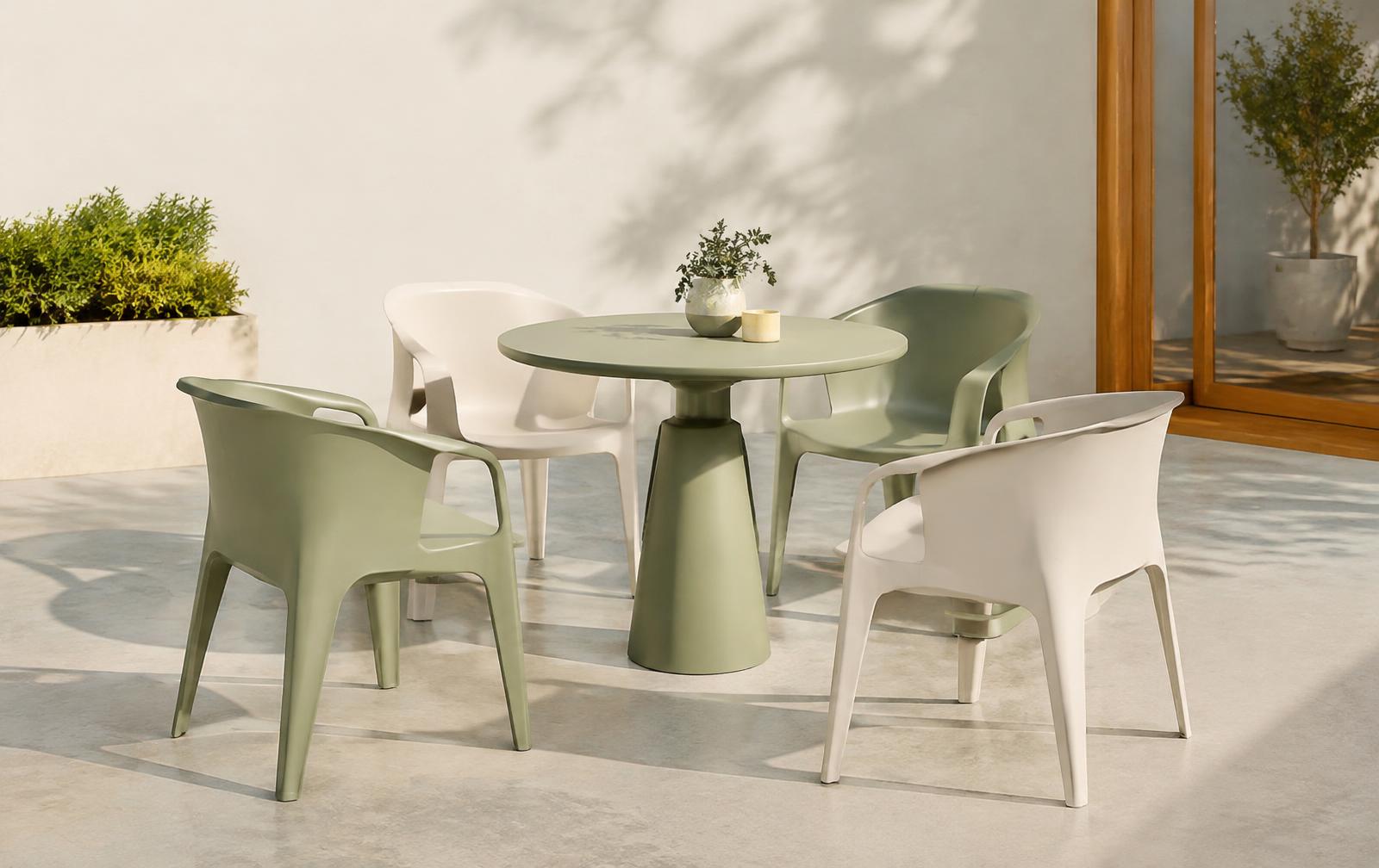 Sage and cream molded plastic armchairs around a round pedestal table on a sunny patio